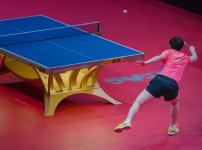 Sun Yingsha Reaches to Return a Topspin Shot.jpg